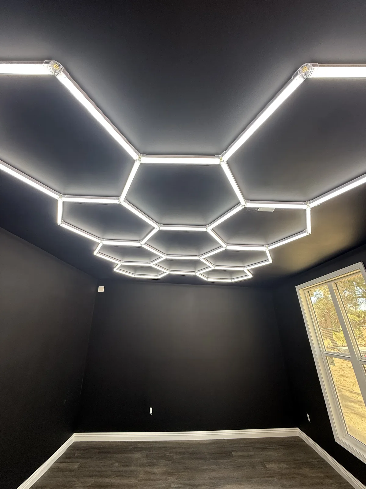 A custom hexagon LED ceiling-light array installed by Genius Electric Corp