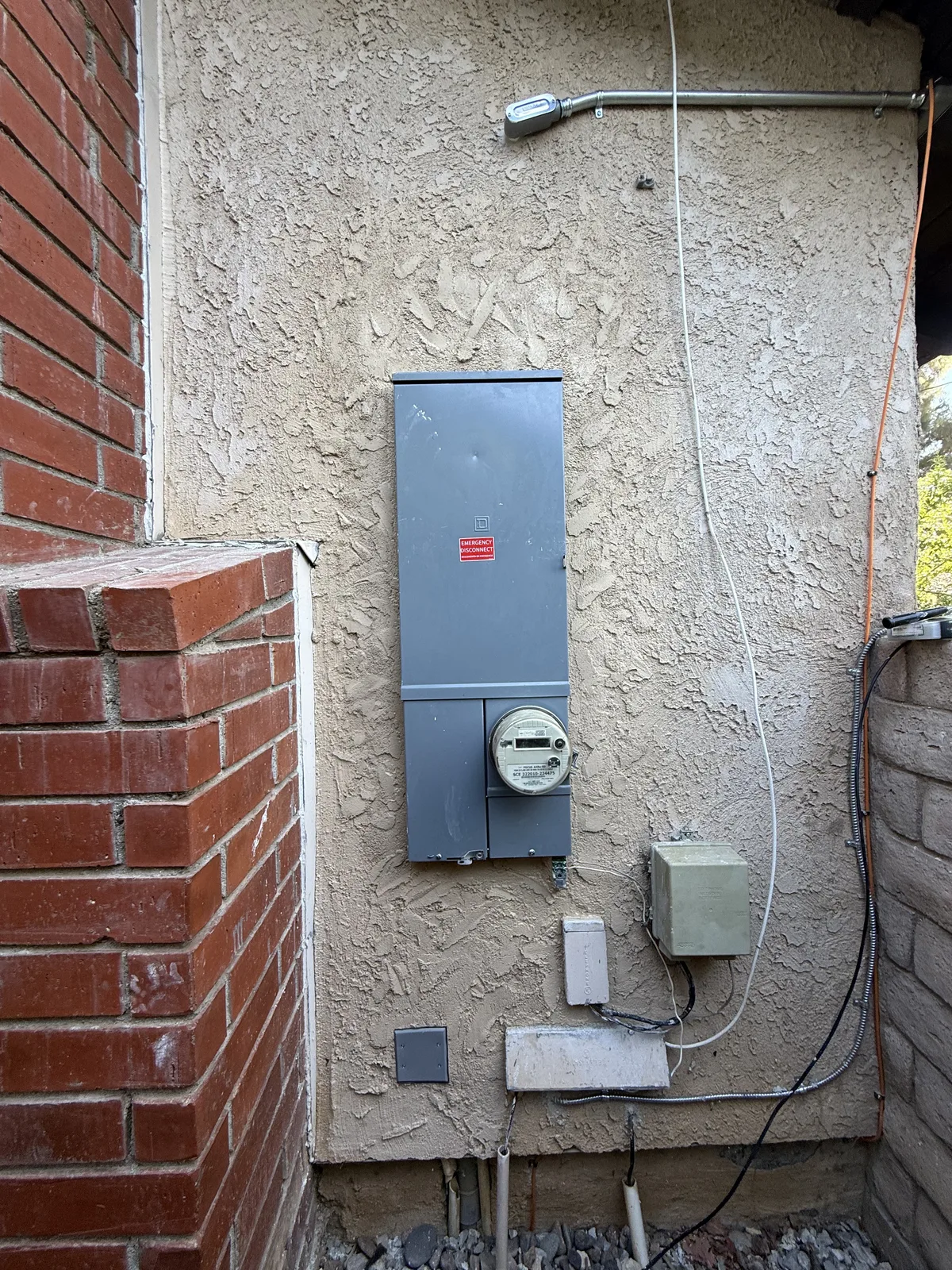 A newly installed exterior electrical service panel and meter by Genius Electric Corp